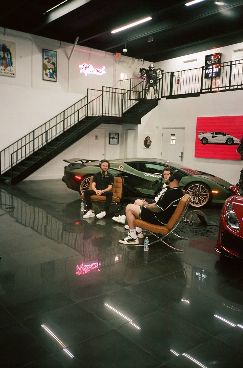 Dawson Gant in a podcast and interview setup at MPH Club with a Lamborghini behind him